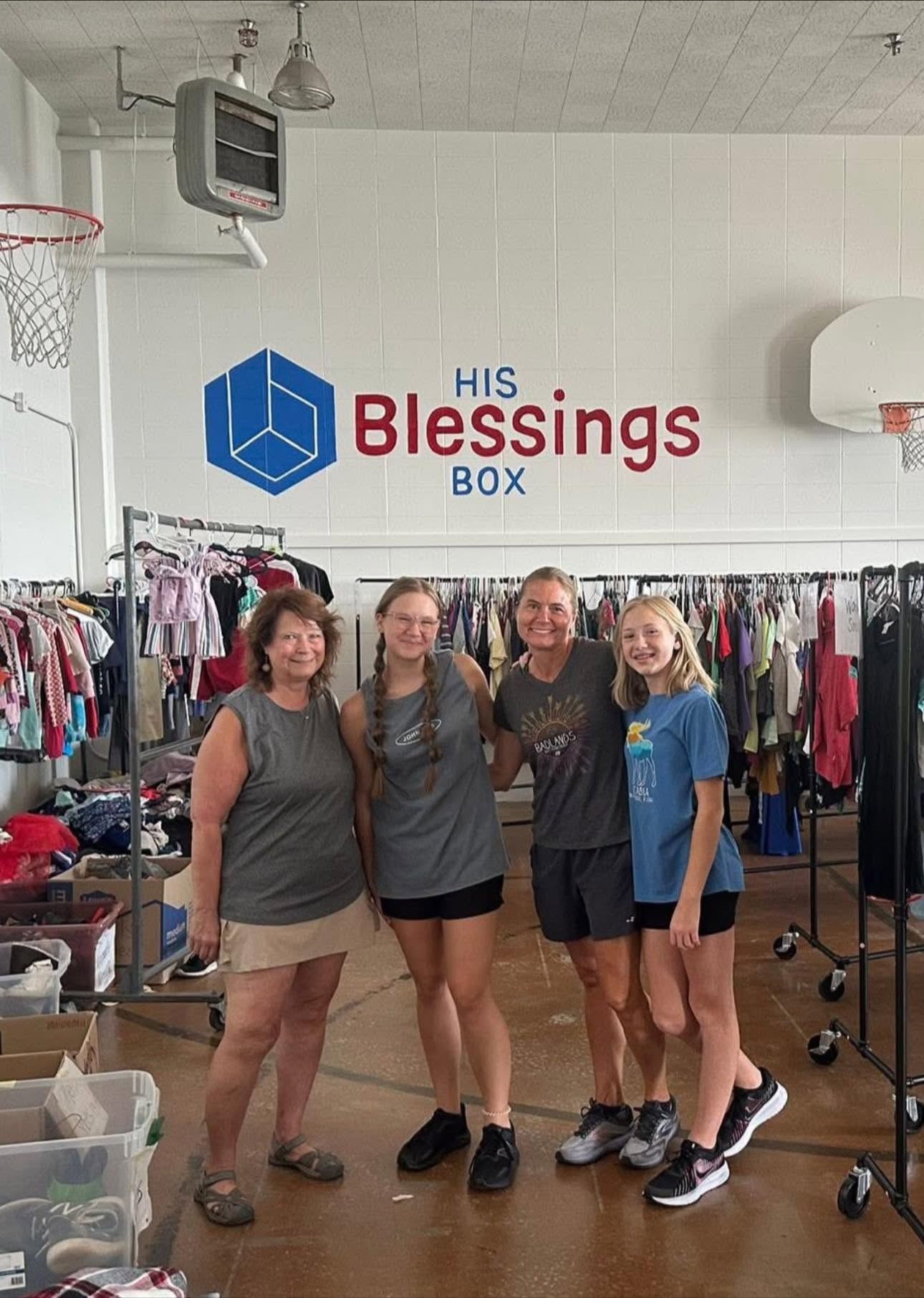 A group of volunteers standing together in the clothing closet