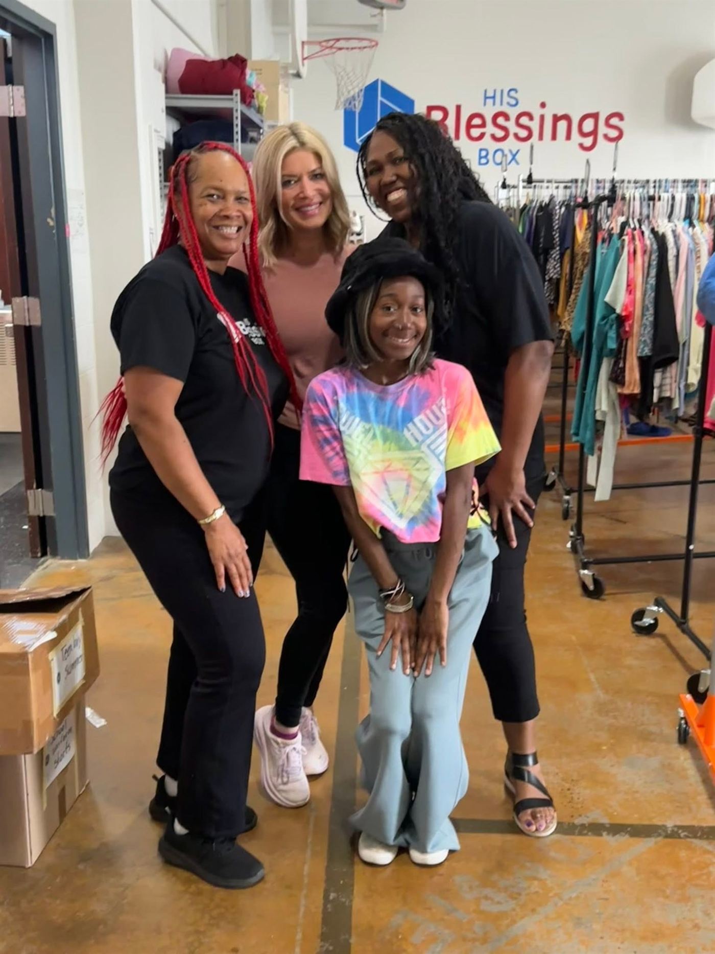 Volunteers sorting and hanging donated clothing